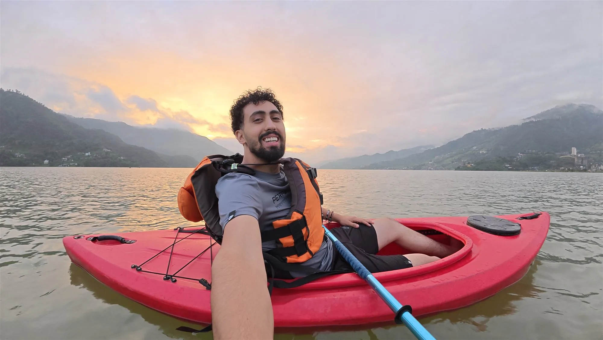 Mohammad kayaking on a mountain lake at sunset during the Everest trip
